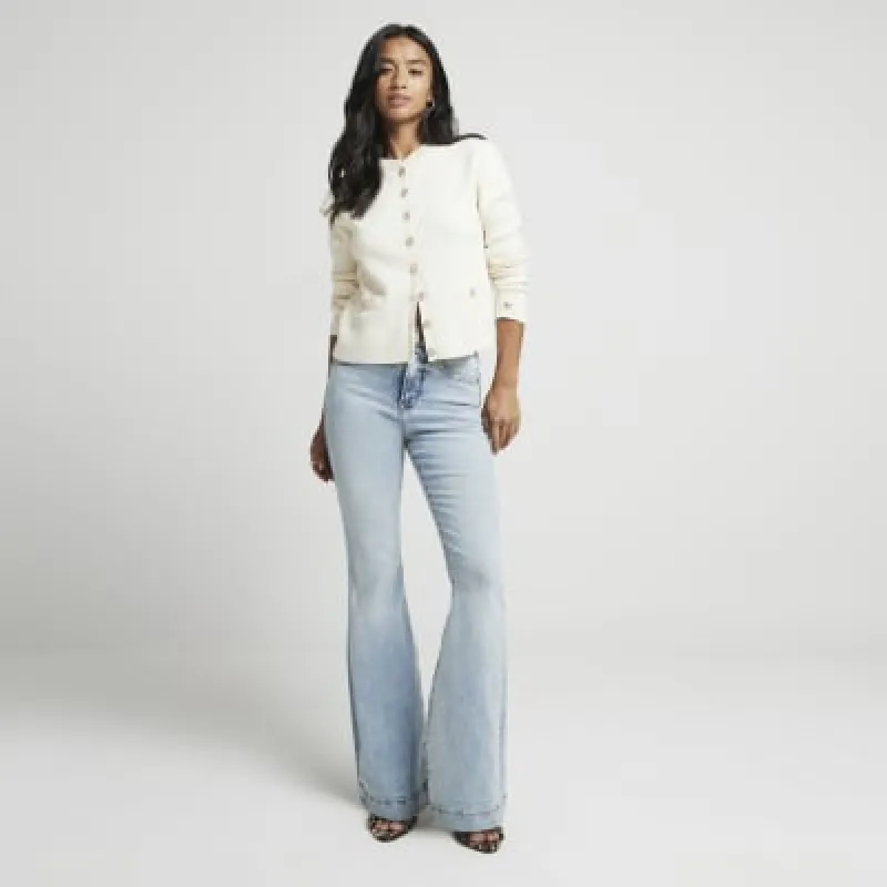Petite blue high waisted flared jeans made by River Island