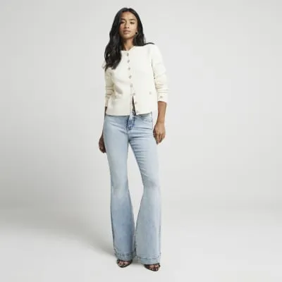 Petite blue high waisted flared jeans sold by River Island