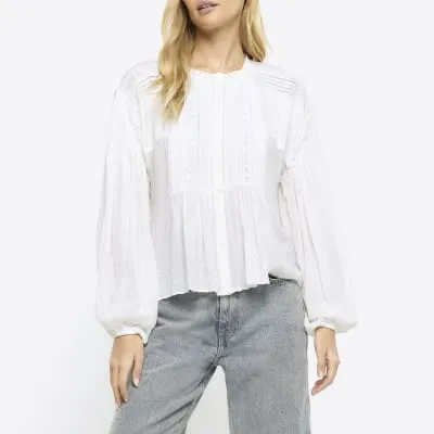 White lace pleated smock blouse sold by River Island