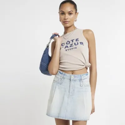 Blue pleated denim mini skirt sold by River Island