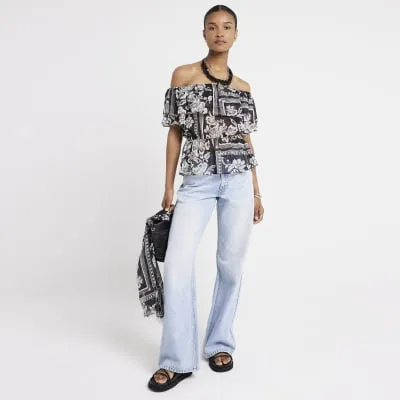 Black floral frill bardot top sold by River Island
