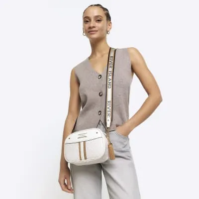 White RI monogram cross body camera bag sold by River Island