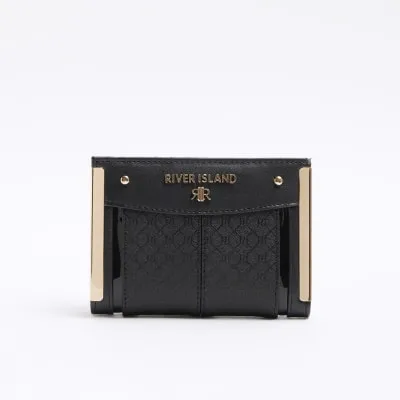 Black embossed monogram purse sold by River Island