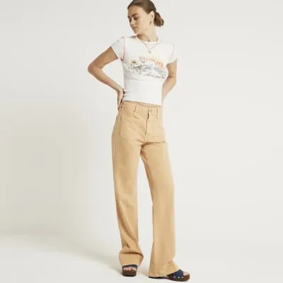 Orange high waisted flared jeans sold by River Island