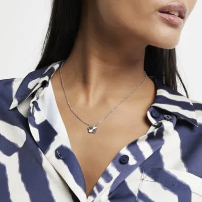 Silver flower necklace sold by River Island