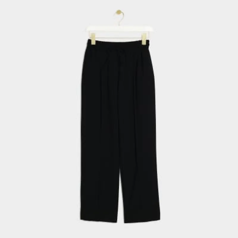 Petite black tailored joggers sold by River Island