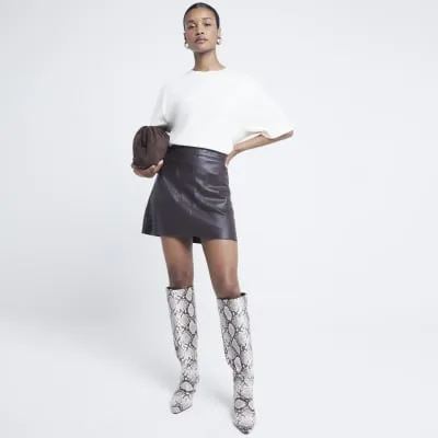 Brown faux leather pocket mini skirt sold by River Island