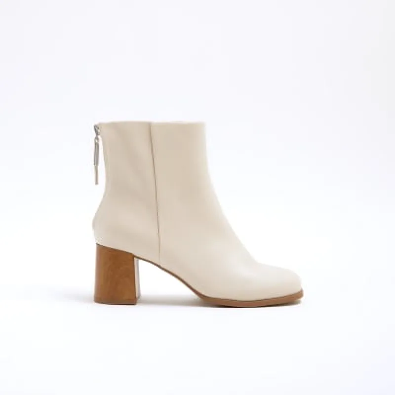 Cream wide fit block heeled ankle boots sold by River Island
