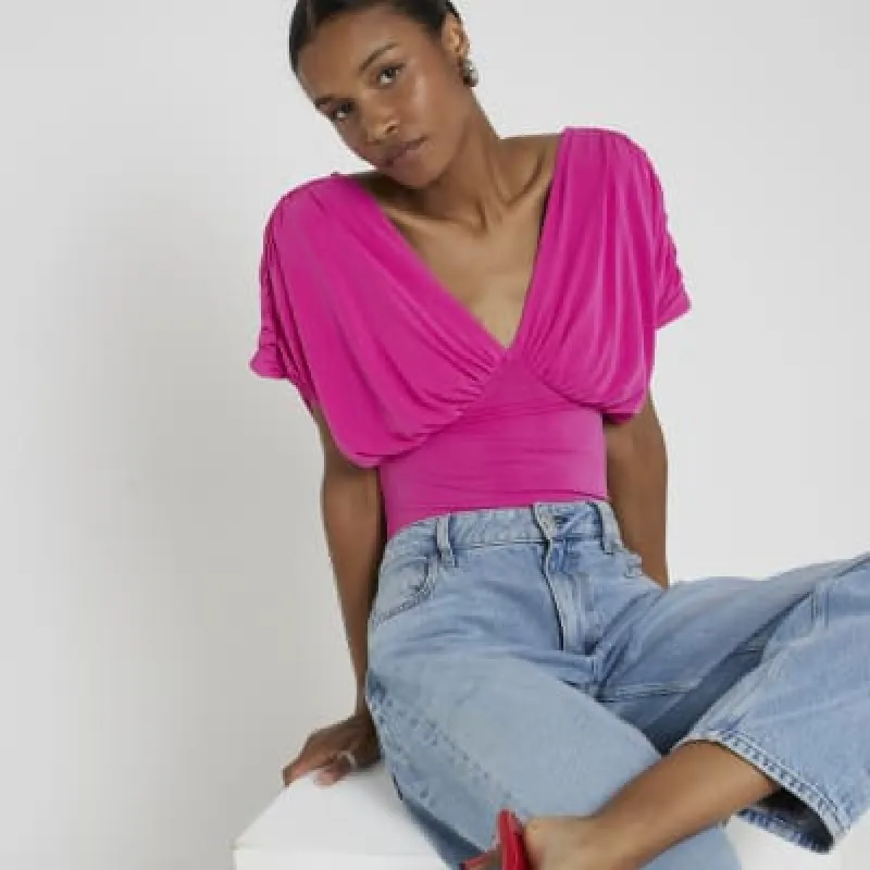 Pink drape plunge bodysuit sold by River Island