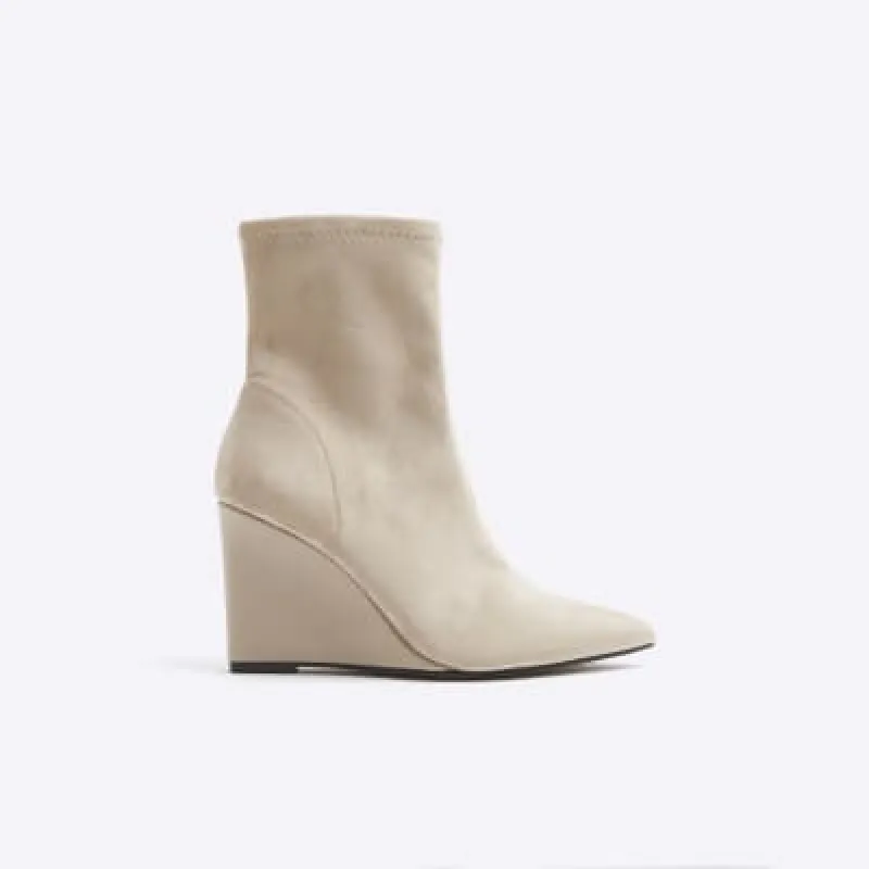 Beige suedette wedge heeled ankle boots sold by River Island
