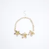 Gold flower collar necklace sold by River Island