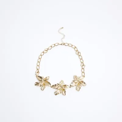 Gold flower collar necklace sold by River Island