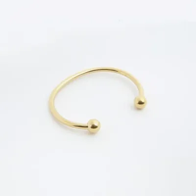 Gold colour stainless steel bracelet sold by River Island