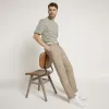 Beige slim fit belted chino trousers sold by River Island