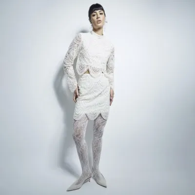 Cream Scalloped Pearl mini Skirt sold by River Island