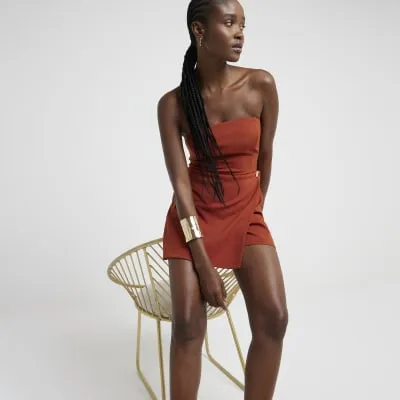 Rust bandeau wrap playsuit sold by River Island