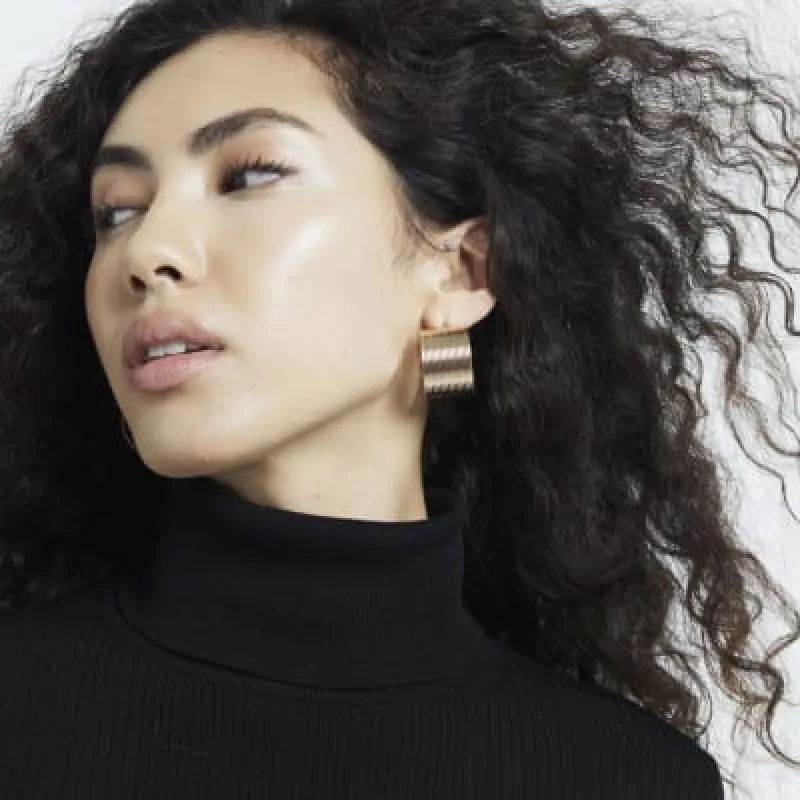 Gold Ribbed Wide Hoops Earrings sold by River Island