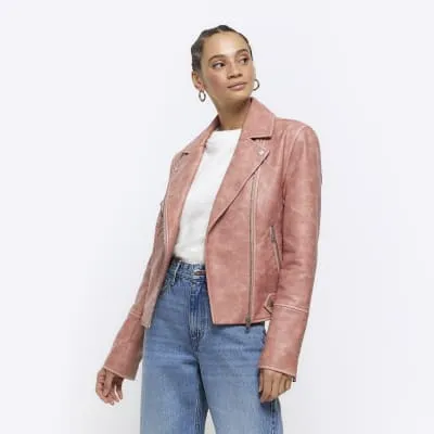 Pink faux leather distressed biker jacket sold by River Island