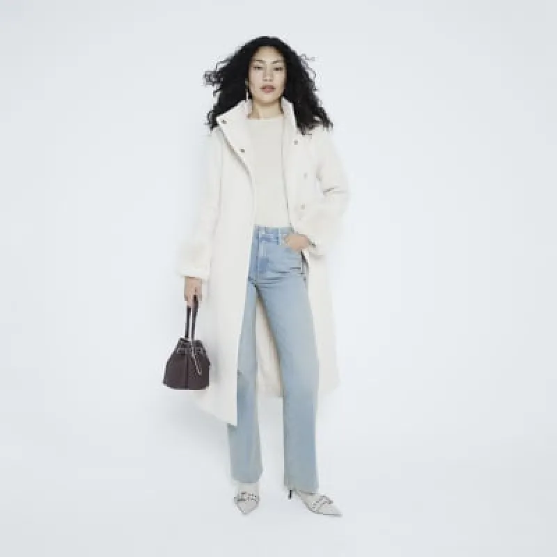 Brown cross body bucket bag sold by River Island