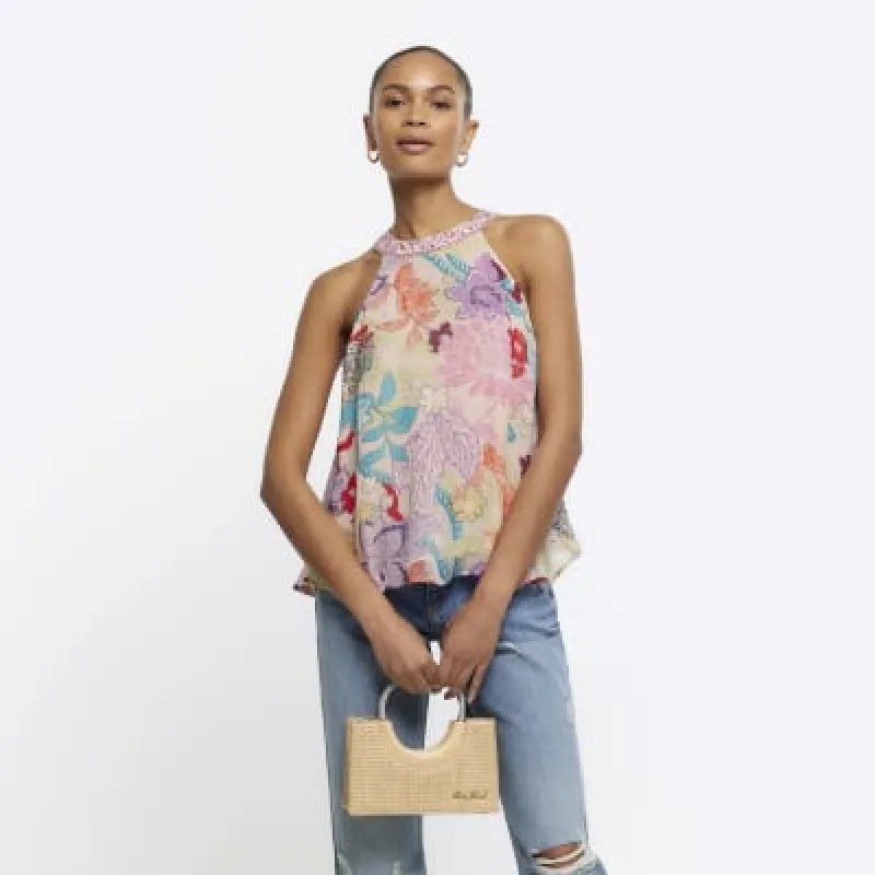 Pink floral halter neck top sold by River Island