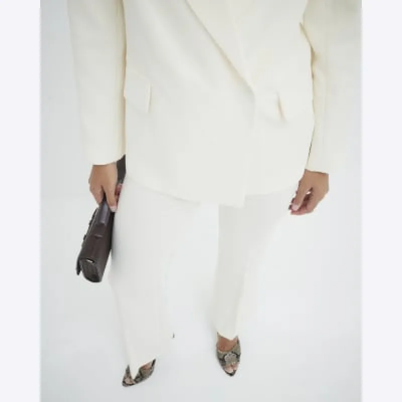 Cream Slim Fit Flared Trousers sold by River Island