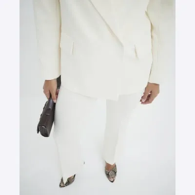 Cream Slim Fit Flared Trousers sold by River Island