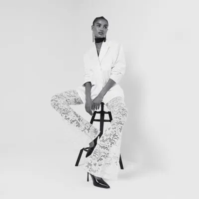 Cream Lace Flare Trousers sold by River Island