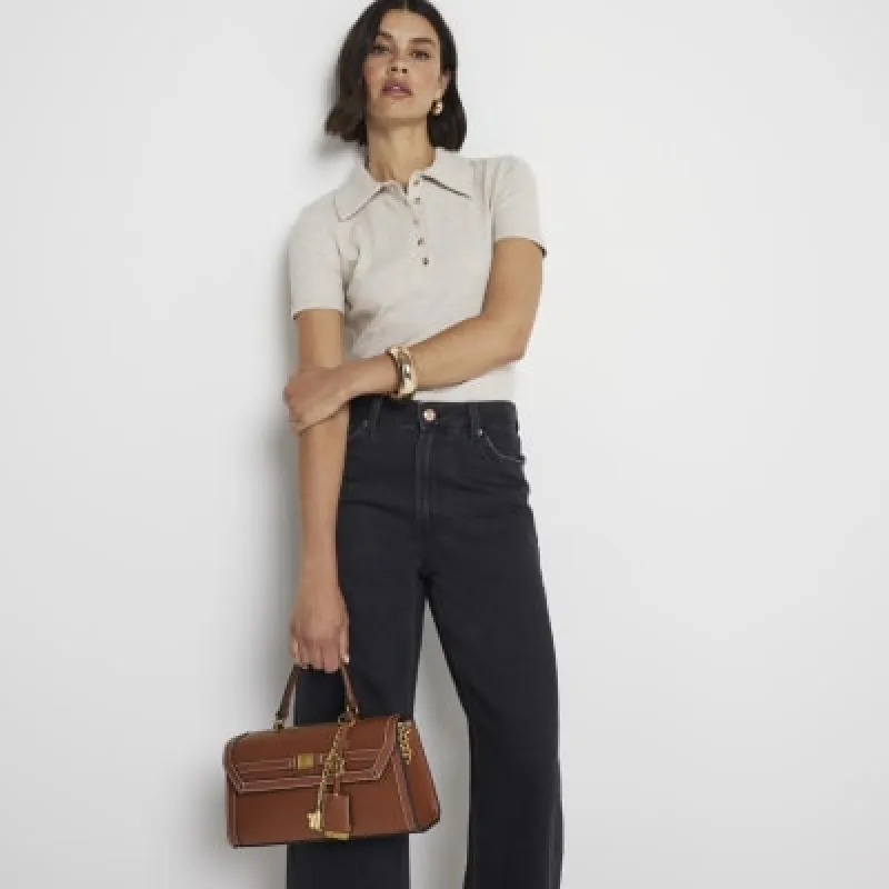Brown charm cross body top handle bag sold by River Island
