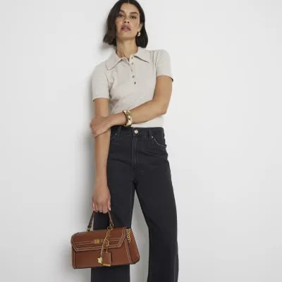 Brown charm cross body top handle bag sold by River Island