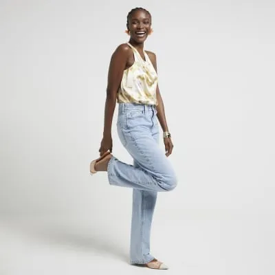 Yellow satin floral halter neck top sold by River Island