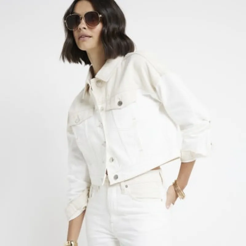 Beige crop denim jacket sold by River Island