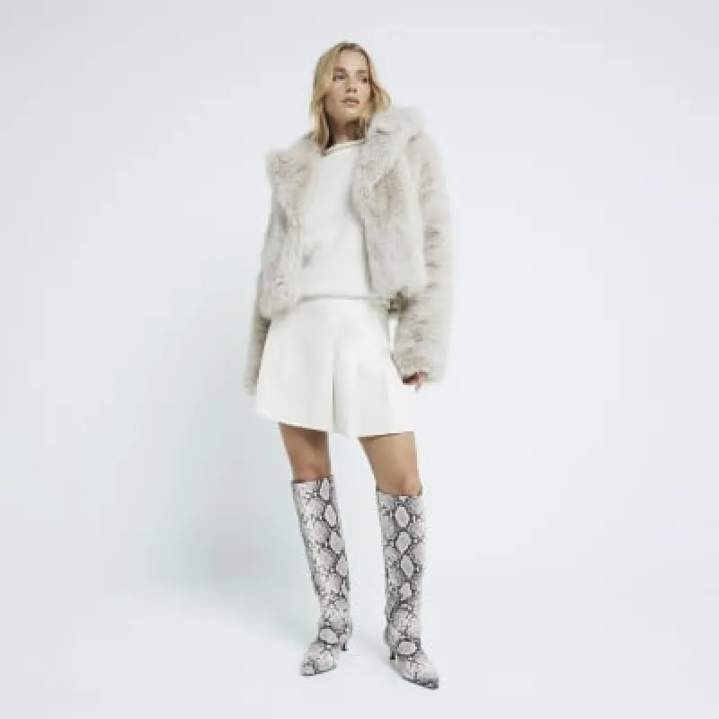Cream faux leather pleated mini skirt sold by River Island