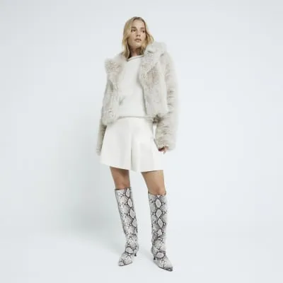 Cream faux leather pleated mini skirt sold by River Island