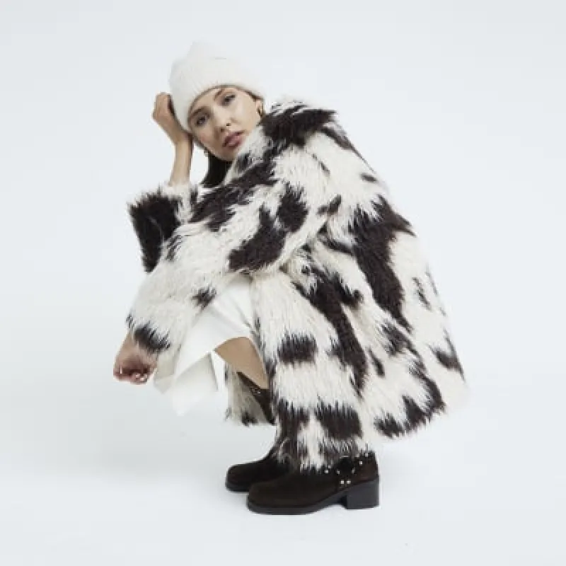 Cream Faux Fur Cow Print Coat sold by River Island