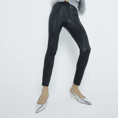 Black High Waisted Snake Flared Leggings sold by River Island