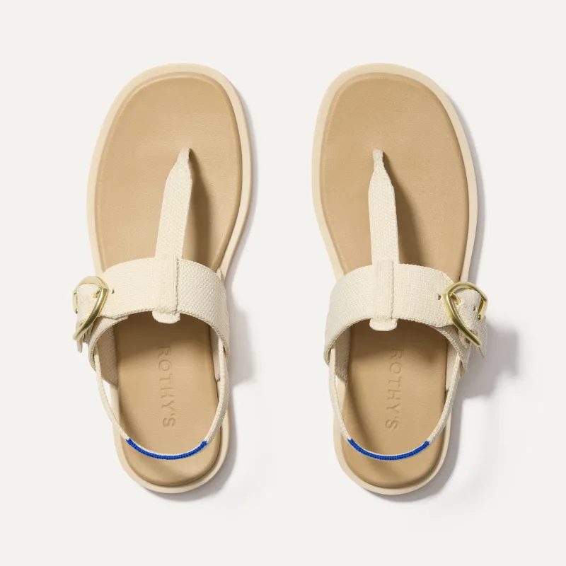 The T–Strap Sandal - Cream Puff sold by Rothy's