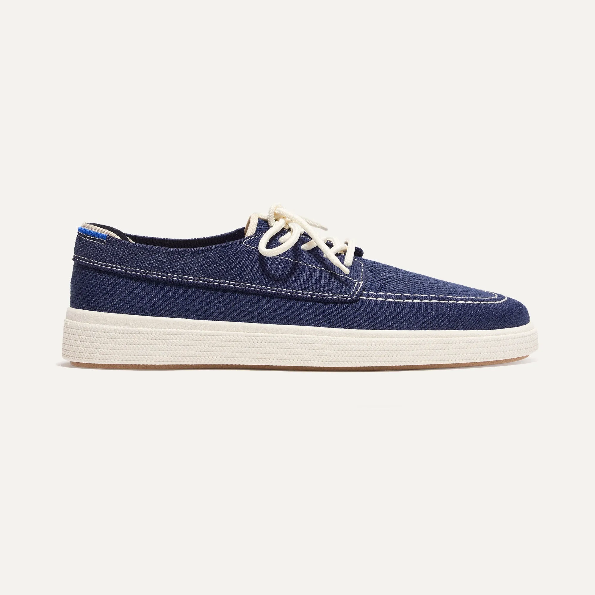 The Ravello Boat Shoe - Nautical Navy sold by Rothy's