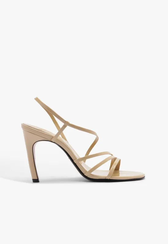 Annie Curve Patent Sandal sold by SCHUTZ
