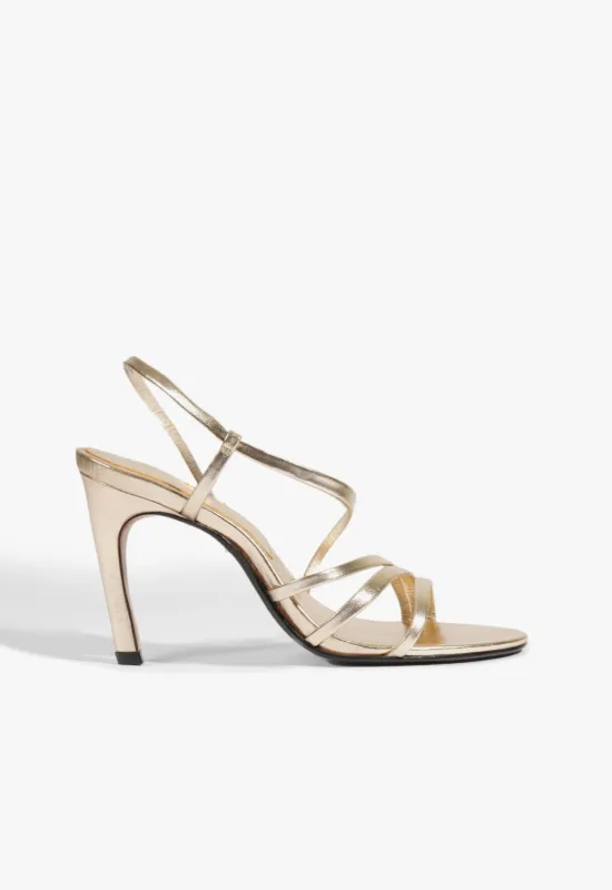 Annie Curve Metallic Sandal sold by SCHUTZ