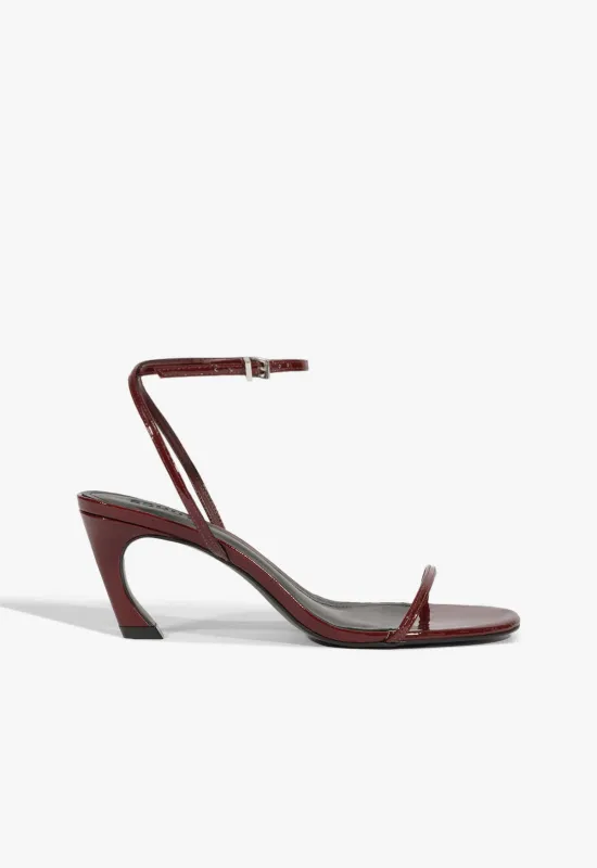 Siena Curve Mid Patent Sandal sold by SCHUTZ