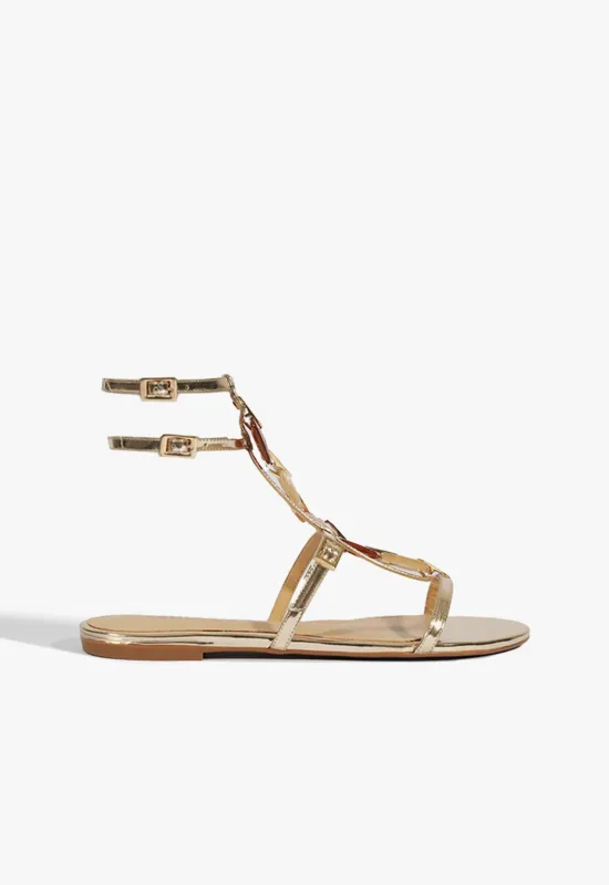 Cassandra Gold Leather Flat Sandal sold by SCHUTZ