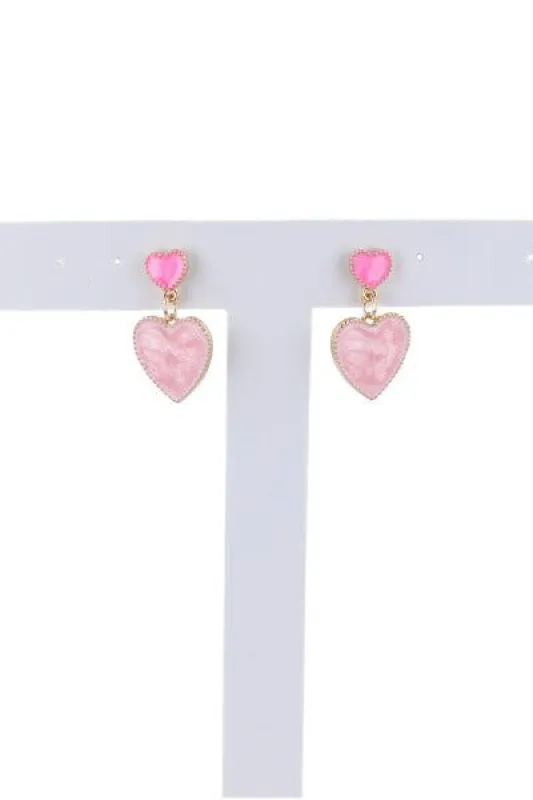 Aretes doble corazón sold by Shasa