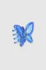 Pinza mariposa transparente brillos sold by Shasa