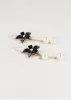Aretes Largos Flor Perlas sold by Shasa
