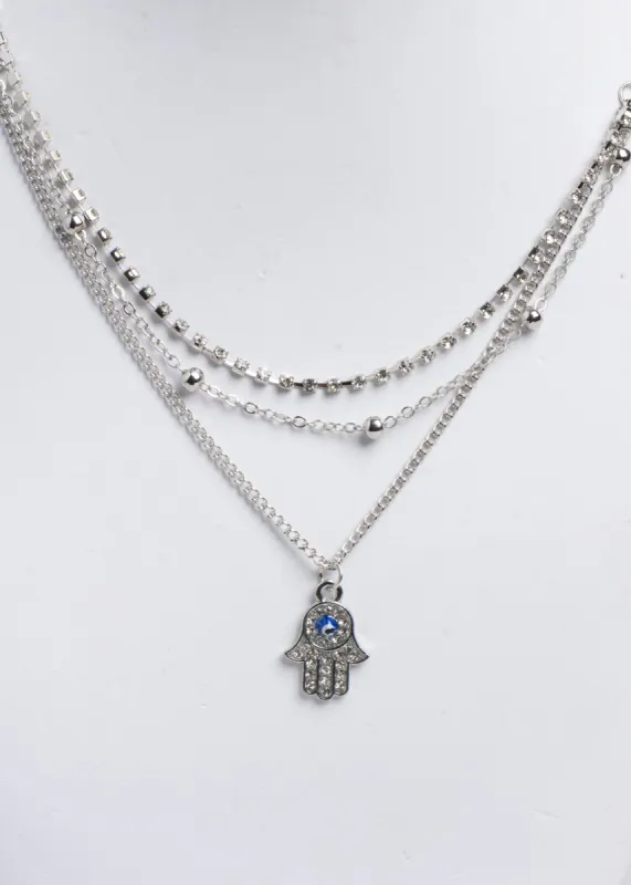 Collar capas mano hamsa sold by Shasa
