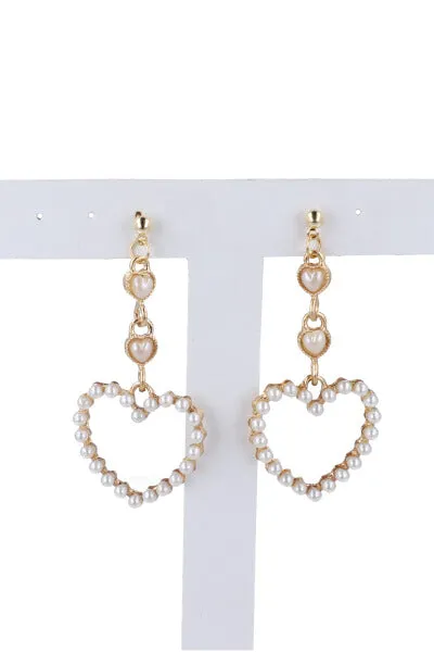 Aretes midi corazones perlas sold by Shasa