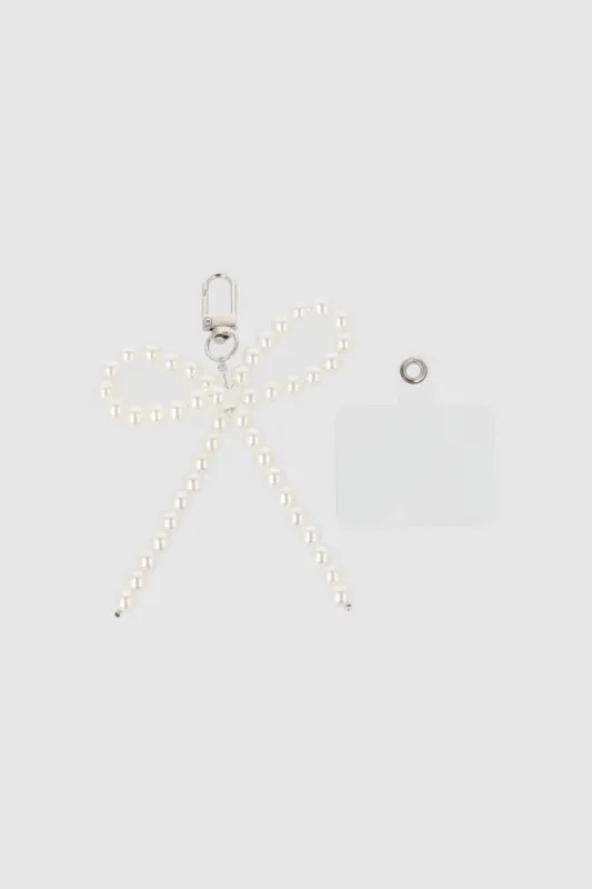 Charm cel moño perlas sold by Shasa