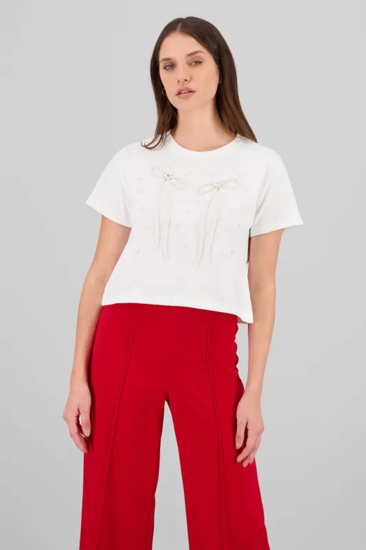 Playera manga corta detalle moños perlas sold by Shasa