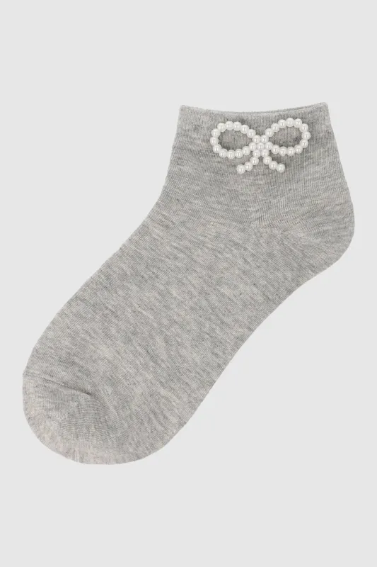 Tin moño perlitas sold by Shasa