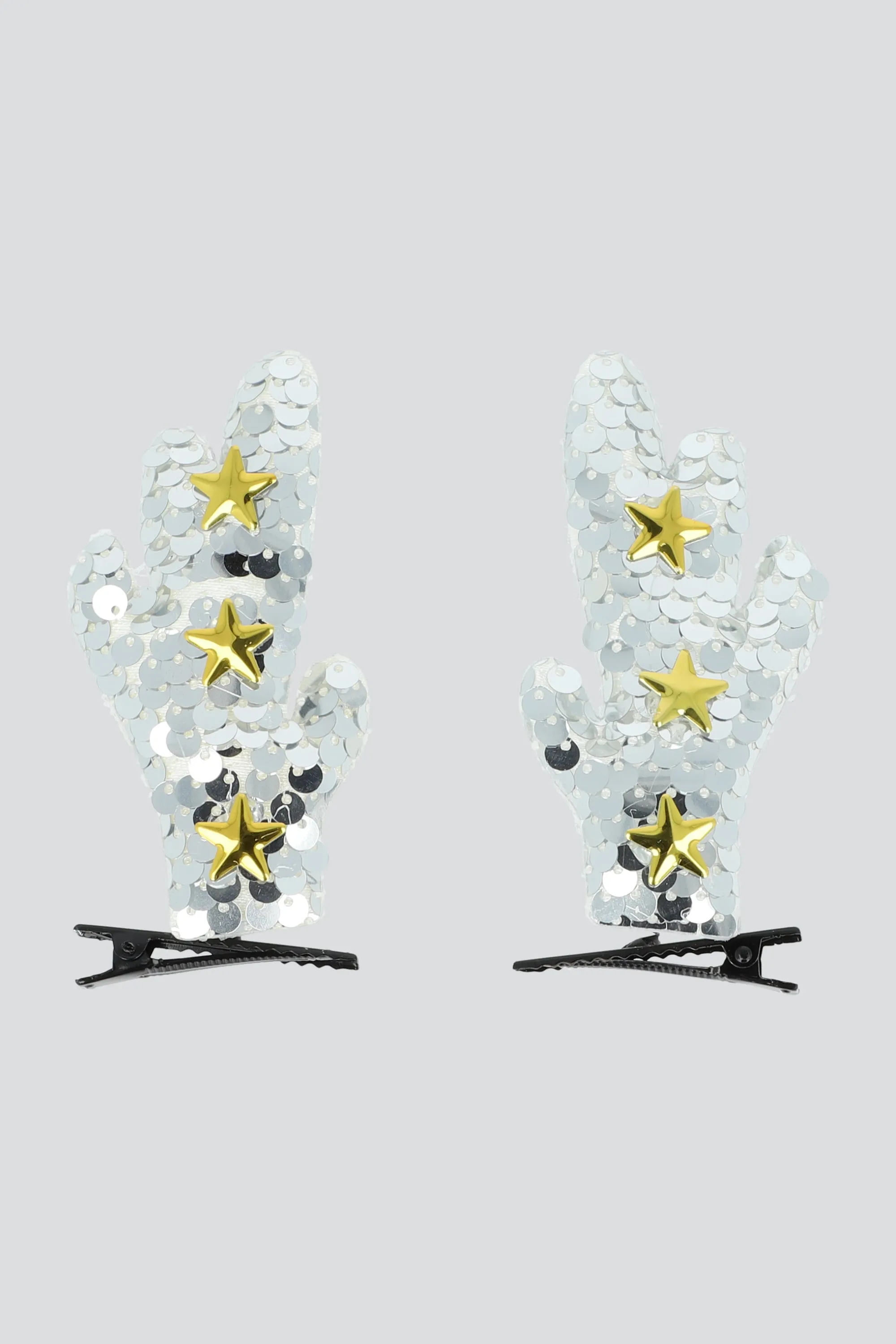 Set 2 broches cuernos lentejuela sold by Shasa